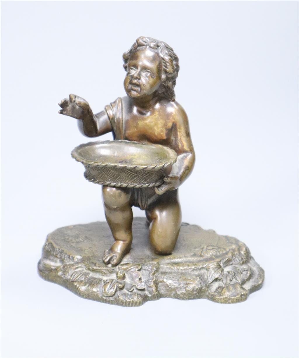 A small Victorian bronze figure of a child and basket, height 12.5cm